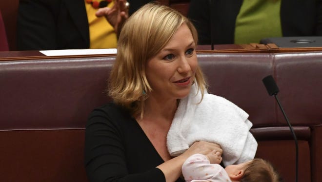 Australian Greens party Sen. Larissa Waters breastfeeds her baby Alia Joy during a session in the Senate Chamber at Parliament House in Canberra, Australia, Tuesday, May 9, 2017.