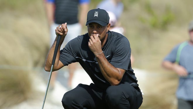 Tiger Woods lines up a putt on the first hole during Round 1 of the Hero World Challenge.