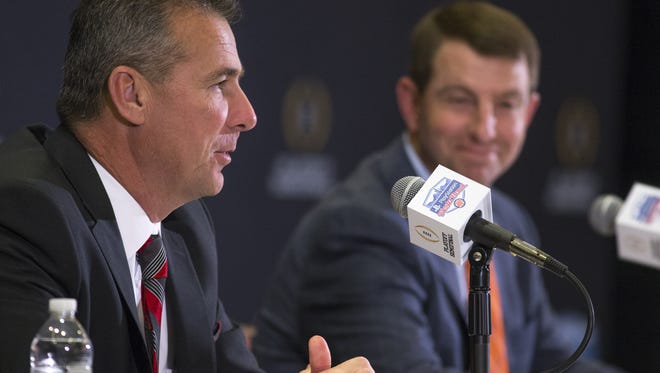 Ohio State's coach Urban Meyer, left, and Clemson's coach Dabo Swinney answer questions during a Fiesta Bowl press conference.