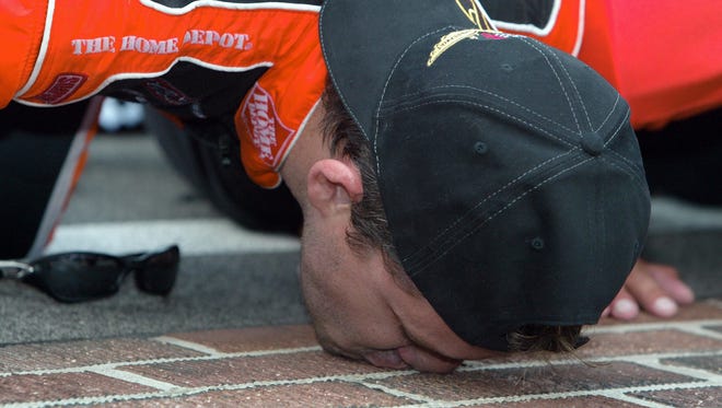 Tony Stewart kisses the bricks after winning the Allstate 400 at the Brickyard in 2005, his first NASCAR victory at his home track.