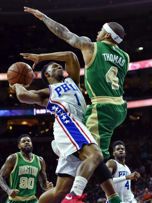March 20, 2016; Philadelphia 76ers guard Ish Smith (1) goes up for a shot and is fouled by Boston Celtics guard Isaiah Thomas (4).