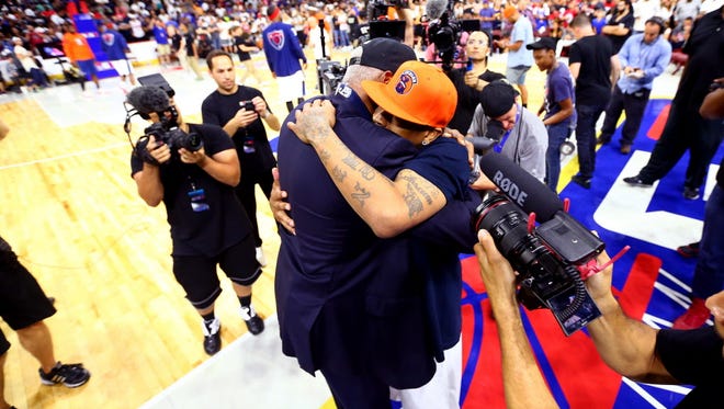 Allen Iverson of 3's Company hugs coach Julius "Dr. J" Erving of Tri-State during Week 4.