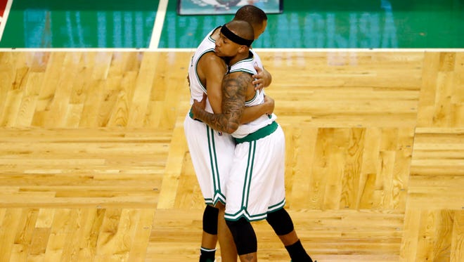 Boston Celtics guard Isaiah Thomas (4) gets a hug from guard Avery Bradley (0) after hitting a shot against the Chicago Bulls during the first quarter in game one of the first round of the 2017 NBA Playoffs.