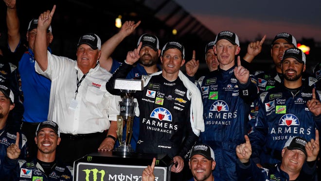 Kasey Kahne (with towel), team owner Rick Hendrick (white shirt) and the rest of the No. 5 Chevrolet team celebrate Kahne's win in the Brickyard 400 on July 23.