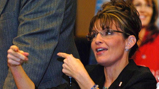 Palin interacts with a customer during a book-signing event in Henrietta, N.Y., on Nov. 21, 2009.