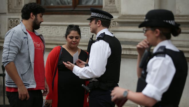 Police officers distribute leaflets to members of the public in central London  May 23, 2017, giving them advice on who to call if they spot something they deem to be suspicious or terrorist-related.