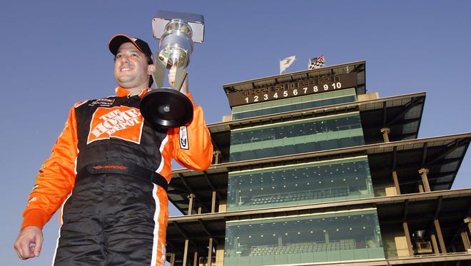 Tony Stewart poses with the champion's trophy after winning the Allstate 400 at the Brickyard in 2007.
