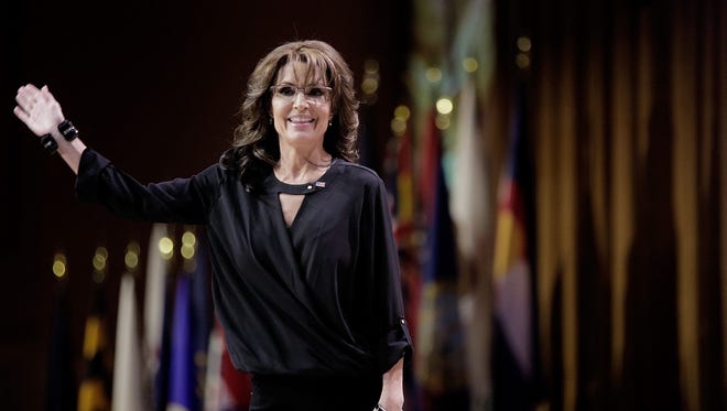 Palin waves as she leaves the stage during the Conservative Political Action Conference on  March 8, 2014, in National Harbor, Md.