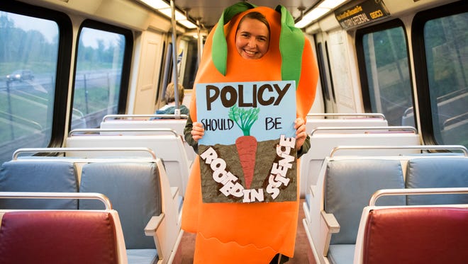 Abby Dilk of Vienna, Va., rides the Metro on her way to the March For Science in Washington, D.C.