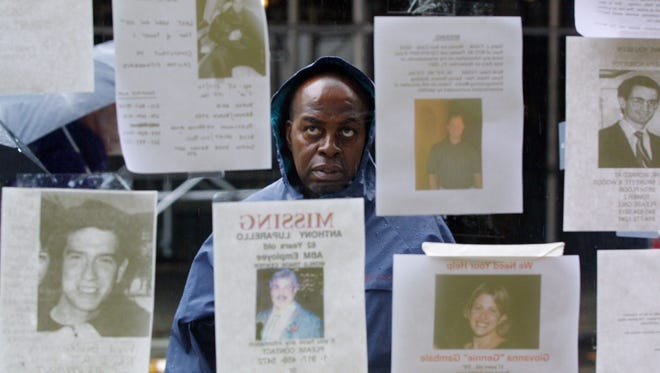 A man looks at photos of people missing in the World Trade Center disaster Sept. 14, 2001.