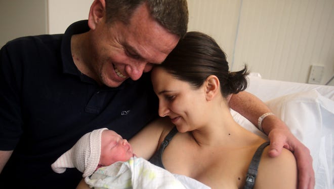Brian and Ashley Larkin of Piermont, N.Y., hold their newborn daughter, Maudie Emilia, on May 13, 2016, at Phelps Memorial Hospital Center in Sleepy Hollow, N.Y. Ashley Larkin gave birth to Maudie in an ambulance in the hospital parking lot after being stranded on the Tappan Zee Bridge.