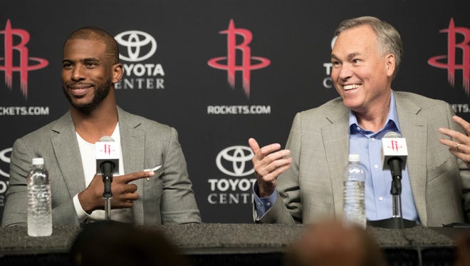 Houston Rockets coach Mike D'Antoni, right, answers a question as Chris Paul, left, reacts during a news conference to introduce Paul as the newest member of the Houston Rockets, Friday, July 14, 2017, in Houston.