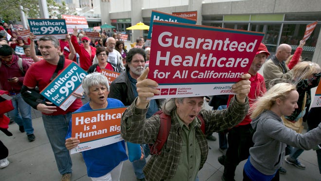 Supporters of single-payer health care march to the Capitol on April 26, 2017, in Sacramento after the California Senate approved  SB 562 that would guarantee health coverage with no out-of-pocket cost for all California residents, including people living in the country illegally.