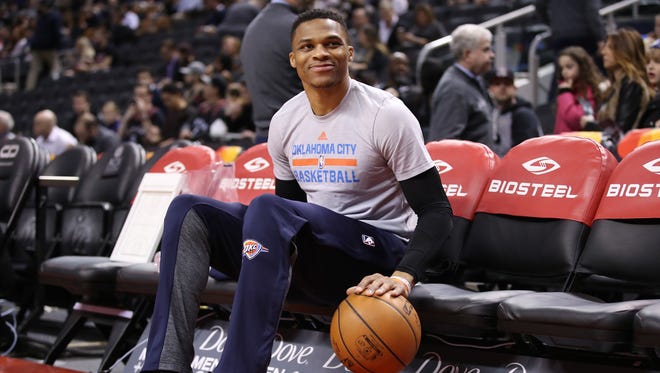 2017: Russell Westbrook does dribbling drills while seated on the bench before the start of their game against the Toronto Raptors.