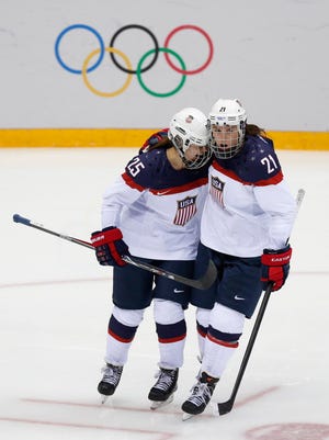 Teams USA forward Hilary Knight (21) congratulates forward Alex Carpenter (25) for her goal during the 2014 Olympics.