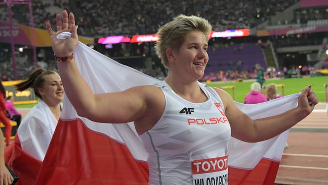 Anita Wlodarczyk of Poland takes a victory lap after winning the hammer throw.