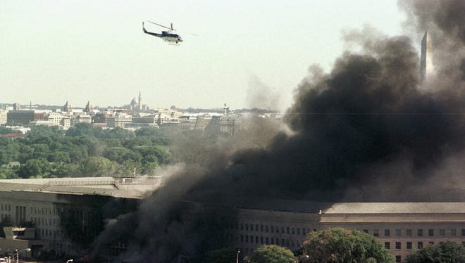 A helicopter flies over the burning Pentagon.
