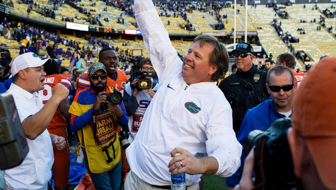 Florida coach Jim McElwain celebrates the win against at Tiger Stadium.