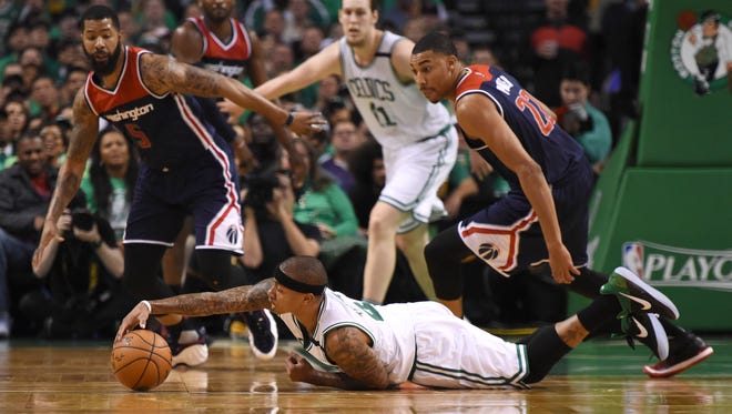 Boston Celtics guard Isaiah Thomas reaches for the ball past Washington Wizards forward Otto Porter Jr. during the first half in Game 7.