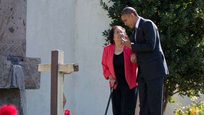 President Obama, accompanied by Cesar Chavez' widow, Helen F. Chavez, places a special "Cesar Chavez" red rose at the gravesite where Cesar E. Chavez was laid to rest in 1993, as he tours the Cesar E. Chavez National Monument Memorial Garden, Oct. 8, 2012, in Keene, Calif.