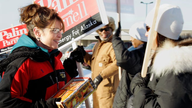 Palin passes out hand warmers to a supporter who braved the cold to wave campaign signs in Anchorage, Alaska, on Nov. 4. 2006, during her gubernatorial campaign.