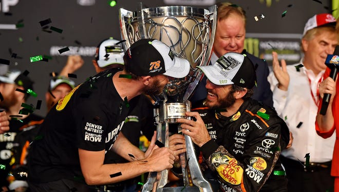 Martin Truex Jr. (78) celebrates with crew chief Cole Pearn after winning the NASCAR Cup Series championship at Homestead-Miami Speedway on Nov. 19.