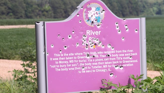 The sign that marks where Emmett Till's body was found in the Tallahatchie River has been riddled with bullets.