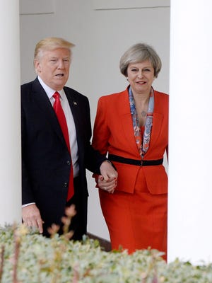 President Trump holds hands with British Prime Minister Theresa May as they walk the colonade of the White House in Washington, Jan. 27, 2017.