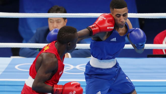 Galal Yafai of Great Britain takes a punch from Simplice Fotsala of Cameroon at Riocentro - Pavilion 6 during the Rio 2016 Summer Olympic Games.