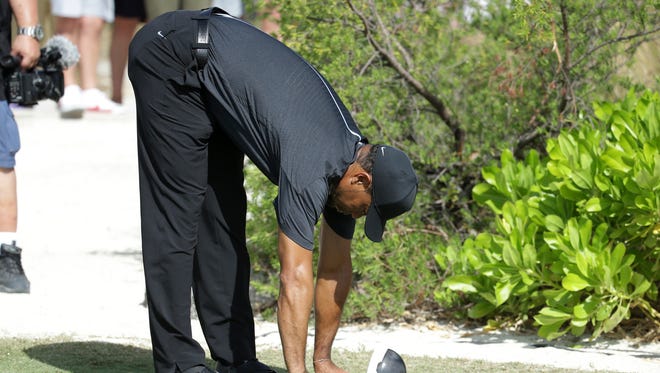 Tiger Woods stretches before teeing off on the first hole during Round 1 of the Hero World Challenge.