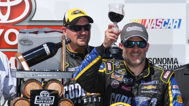 Tony Stewart raises the customary chalice full of wine after his victory at Sonoma Raceway on June 26, 2016.