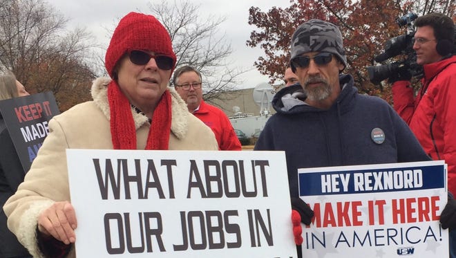 Susan Cooper, a Carrier employee from Huntington, Ind., and Gary Canter, a Rexnord employee in Indianapolis, face layoffs in the coming months. They greeted President-elect Donald Trump's arrival Thursday, Dec. 1, 2016, with messages about their own plights.
