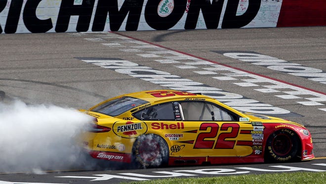 Joey Logano leaves a smoke trail as he celebrates his first win of the season.