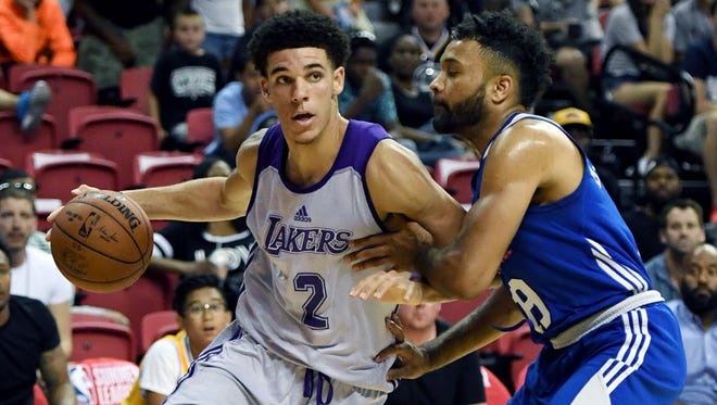 Lakers guard Lonzo Ball drives to the basket against 76ers guard James Blackmon Jr. during their summer league game at the Thomas & Mack Center in Las Vegas.