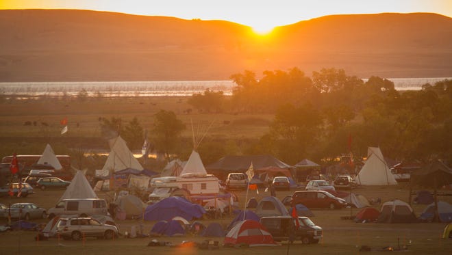 Sunrise over Lake Oahe and a protest camp near the Standing Rock Reservation Thursday, Sept. 29, 2016, near Cannon Ball, North Dakota. The Dakota Access pipeline passes less than two miles from the camp and will go under Lake Oahe/Missouri River.