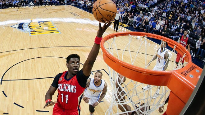 New Orleans Pelicans guard Jrue Holiday (11) drives to the net in the third quarter against the Denver Nuggets at the Pepsi Center. The Pelicans won 115-90.