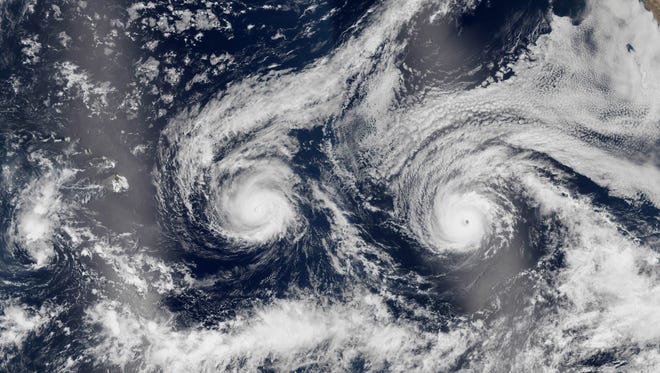This satellite image taken Aug. 29, 2016 shows Hurricane Madeline, left, and Hurricane Lester over the Pacific Ocean in a composite built from two overpasses by the Visible Infrared Imaging Radiometer Suite on the Suomi NPP satellite.