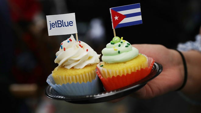 Cupcakes with JetBlue and Cuban flags are are passed out in Ft. Lauderdale, Fla. before the first scheduled commercial flight to Cuba since 1961.