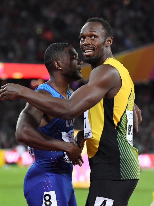 Gold medalist Justin Gatlin embraces bronze medalist Usain Bolt .