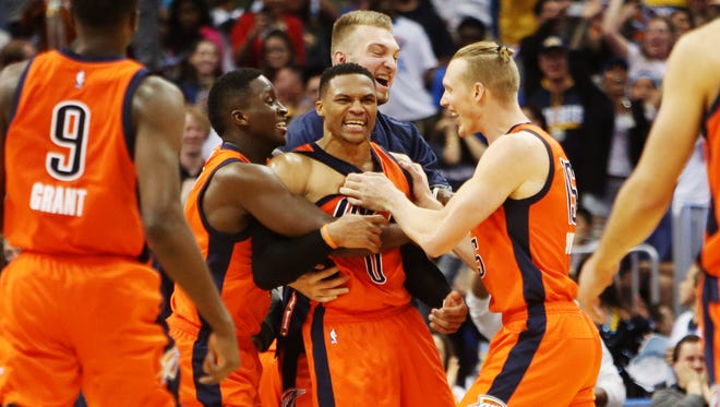 Russell Westbrook gets mobbed after sinking a game-winning 3 at the buzzer.