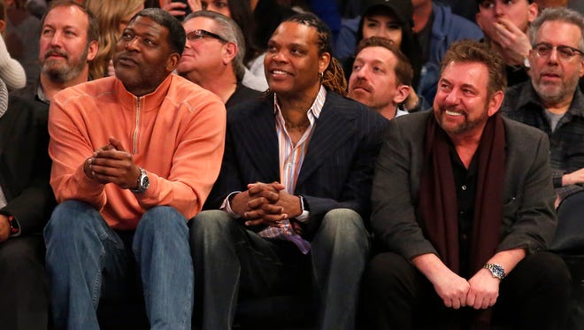 Larry Johnson and Latrell Sprewell look on with New York Knicks executive chairman James Dolan during the second half against the San Antonio Spurs at Madison Square Garden.