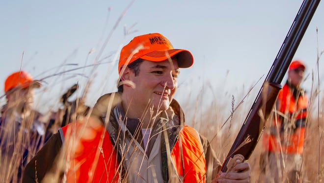 Cruz walks through tall grass during an Oct. 26, 2013, pheasant hunt hosted by Rep. Steve King, R-Iowa, in Akron.