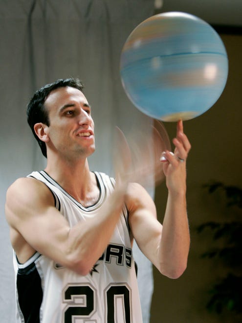 2006: Ginobili spins a globe on his finger while posing for a photograph during media day in San Antonio.