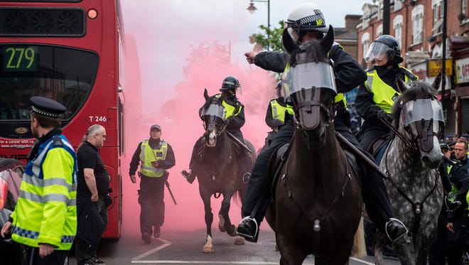 Mounted policemen prepare to intervene during clashes between Arsenal and Tottenham fans.