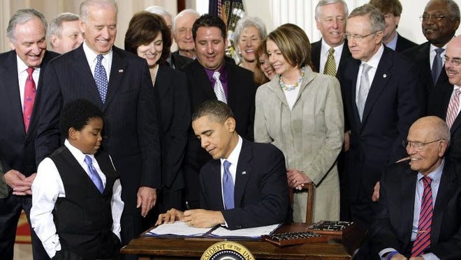 President Obama signs ACA into law in 2010.