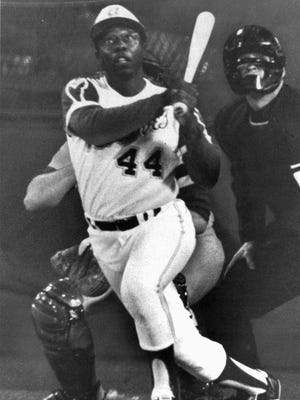 Hank Aaron, Atlanta Braves slugger, eyes the flight of the ball after hitting his 715th homer to break Babe Ruth's all-time home run record in 1974 in Atlanta against the Los Angeles Dodgers.