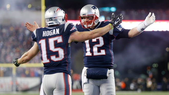 Patriots quarterback Tom Brady (12) celebrates after throwing a touchdown pass to wide receiver Chris Hogan (15) during the second quarter.