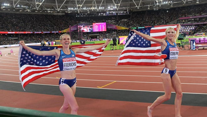 Emma Coburn (USA) and Courtney Frerichs (USA) take a victory lap with United States flags after placing first and second in the women's steeplechase in a championship record 9:02.58 and 9:03.77 during the IAAF World Championships in Athletics at London Stadium at Queen Elizabeth Park.
