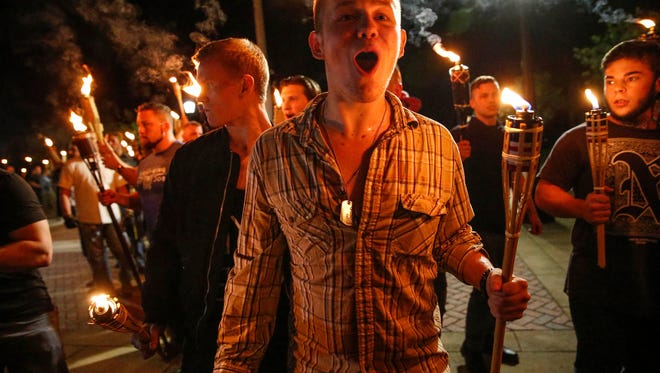 White nationalist groups march with torches through the UVA campus in Charlottesville.
