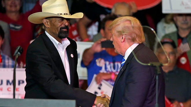 Milwaukee County Sheriff David A. Clarke Jr. (left) greets Donald Trump at a rally at the Waukesha Expo Center in September.